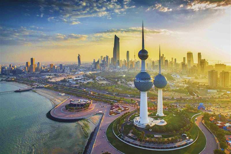Kuwait Visa Kuwait City skyline at sunset with Kuwait Towers and modern skyscrapers overlooking the Arabian Gulf waterfront